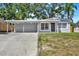 Charming single-story home with a convenient carport and well-manicured lawn, creating a welcoming curb appeal at 10218 Lola St, Tampa, FL 33612