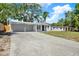 Well-maintained single-story home with a spacious driveway and a well-manicured lawn, creating a welcoming curb appeal at 10218 Lola St, Tampa, FL 33612