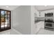 Renovated kitchen showcasing white cabinets, granite countertops and stainless steel appliances at 10218 Lola St, Tampa, FL 33612