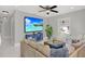 Spacious living room featuring a comfortable sofa, modern decor, and a large TV for entertaining at 10218 Lola St, Tampa, FL 33612