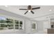 Bright living room with a ceiling fan, neutral paint, and large windows at 10218 Lola St, Tampa, FL 33612