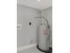 A close up shows a gray, modern AO Smith water heater in a room with marbled floors and gray walls at 10218 Lola St, Tampa, FL 33612