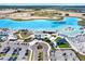 Community aerial view of amenities with parking, recreation, and a pristine lagoon, great for resort-style living at 11443 Cay Spruce Way, San Antonio, FL 33576