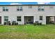The backyard has a well-maintained lawn and screened-in porches at 11443 Cay Spruce Way, San Antonio, FL 33576