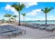 Stunning beach with lounge chairs and palm trees offering the perfect spot for relaxation and soaking up the sun at 11443 Cay Spruce Way, San Antonio, FL 33576