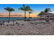 Community sand beach featuring a covered area with dining and lounge seating near the water at 11443 Cay Spruce Way, San Antonio, FL 33576