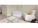 Cozy Bedroom with a white crib, armchair, and soothing decor for a peaceful atmosphere at 11443 Cay Spruce Way, San Antonio, FL 33576