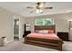 A cozy bedroom is equipped with a mini-fridge and offers access to the ensuite bathroom at 11443 Cay Spruce Way, San Antonio, FL 33576