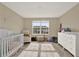 Bright Bedroom featuring neutral decor, a white crib, and a comfortable armchair at 11443 Cay Spruce Way, San Antonio, FL 33576
