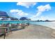 Relaxing community pool area with blue umbrellas, tables, and chairs by the water at 11443 Cay Spruce Way, San Antonio, FL 33576
