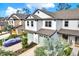 Beautiful townhome featuring a two-car garage, attractive landscaping, and modern architectural design at 11443 Cay Spruce Way, San Antonio, FL 33576