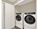 Convenient laundry room showcasing a modern, front-loading washer and dryer at 11443 Cay Spruce Way, San Antonio, FL 33576