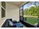 Comfortable screened-in porch with seating, providing a relaxing outdoor space at 11443 Cay Spruce Way, San Antonio, FL 33576