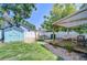 Inviting backyard featuring a cozy deck, storage shed, and well-manicured lawn at 1240 Georgia Ave, Dunedin, FL 34698