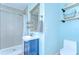 Charming bathroom with blue vanity, walk-in shower, and modern fixtures at 1240 Georgia Ave, Dunedin, FL 34698
