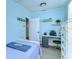 Charming bedroom with a light-blue color scheme, work desk, and plenty of natural light at 1240 Georgia Ave, Dunedin, FL 34698
