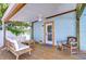 Relax on this cozy covered patio with comfortable seating and a ceiling fan for breezy comfort at 1240 Georgia Ave, Dunedin, FL 34698