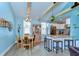 Cozy dining area featuring exposed beams, a dining table set, and open-concept kitchen at 1240 Georgia Ave, Dunedin, FL 34698
