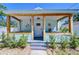 Charming front porch with wooden columns, a porch swing, and seaside-themed decorations at 1240 Georgia Ave, Dunedin, FL 34698
