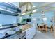 Well-lit kitchen with open floor plan displaying herringbone countertops and stainless steel appliances at 1240 Georgia Ave, Dunedin, FL 34698