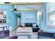 Inviting living room with vaulted ceilings, exposed wood beams, a comfortable couch, and modern decor at 1240 Georgia Ave, Dunedin, FL 34698