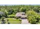 Expansive aerial view showcases the home, landscaped yard, and surrounding lush greenery at 12801 Castlemaine Dr, Tampa, FL 33626