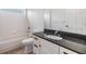 Bathroom featuring vanity with dark countertop, tiled shower and tub at 12801 Castlemaine Dr, Tampa, FL 33626