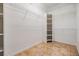 Walk-in closet providing built-in shelving and storage space, plus travertine flooring at 12801 Castlemaine Dr, Tampa, FL 33626