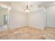 Dining room with stylish light fixture, neutral walls, beautiful tile floors and access to the kitchen at 12801 Castlemaine Dr, Tampa, FL 33626