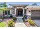 Inviting entryway featuring a stone-accented archway and a modern, dark-stained front door at 12801 Castlemaine Dr, Tampa, FL 33626