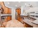 Bright kitchen showcasing wooden cabinets, granite counters, and travertine flooring at 12801 Castlemaine Dr, Tampa, FL 33626