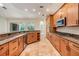 A large kitchen is complete with granite countertops, stainless appliances, and beautiful wood cabinetry at 12801 Castlemaine Dr, Tampa, FL 33626