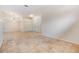 A neutral living room has a closet, doorway, and beautiful tile floors throughout the house at 12801 Castlemaine Dr, Tampa, FL 33626