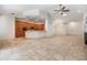 Open living space featuring a large kitchen with stainless steel appliances, ample counter space, and tile flooring at 12801 Castlemaine Dr, Tampa, FL 33626