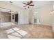 Bright living room featuring tile floors, a ceiling fan and access to a bathroom at 12801 Castlemaine Dr, Tampa, FL 33626