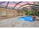 The backyard is perfect for entertaining with a screened in pool and outdoor area at 12801 Castlemaine Dr, Tampa, FL 33626