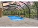 Enjoy the outdoors with this screened in pool complete with fountains and tiled decking at 12801 Castlemaine Dr, Tampa, FL 33626