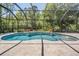 This screened pool features a water feature and a spa for the ultimate outdoor living experience at 12801 Castlemaine Dr, Tampa, FL 33626