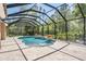 Enjoy the outdoors with this screened in pool complete with fountains and tiled decking at 12801 Castlemaine Dr, Tampa, FL 33626