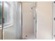 Shower featuring tiled walls, glass door, and chrome hardware at 12801 Castlemaine Dr, Tampa, FL 33626