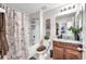 Bathroom with shower-tub combo, tiled walls, updated fixtures, and a stylish vanity with modern decor at 12913 Dream Catcher Way, Riverview, FL 33579