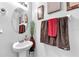 Stylish powder room with decorative mirror, vessel sink, and neutral paint at 12913 Dream Catcher Way, Riverview, FL 33579