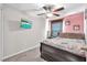 Comfortable bedroom featuring a cozy bed, ample natural light, and a mounted television at 12913 Dream Catcher Way, Riverview, FL 33579
