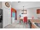 Dining area adjacent to kitchen featuring dark appliances and backyard access through sliding glass doors at 12913 Dream Catcher Way, Riverview, FL 33579