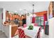 Eat in kitchen featuring dark appliances and adjacent dining area with stylish chandelier and decor at 12913 Dream Catcher Way, Riverview, FL 33579