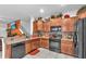 Well-equipped kitchen featuring granite countertops, modern appliances, mosaic tile backsplash, and ample storage space at 12913 Dream Catcher Way, Riverview, FL 33579