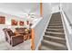 Inviting living room with comfortable seating, neutral tones, and a staircase at 12913 Dream Catcher Way, Riverview, FL 33579