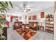 Spacious living room with tile flooring, ceiling fan, and a cozy seating area at 12913 Dream Catcher Way, Riverview, FL 33579