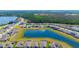 Neighborhood aerial view showcases well-maintained homes, landscaping, and a beautiful lake at 13246 Twin Bridges Dr, Riverview, FL 33579