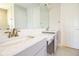 Bathroom with dual sinks, light gray cabinets, and a large mirror reflecting natural light at 13246 Twin Bridges Dr, Riverview, FL 33579